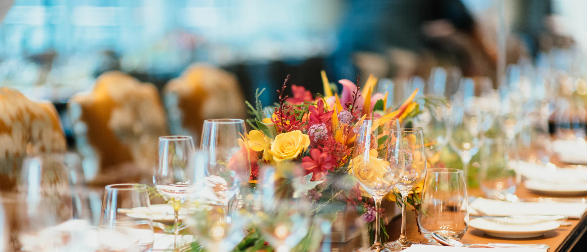 A long reception table with flowers and candles