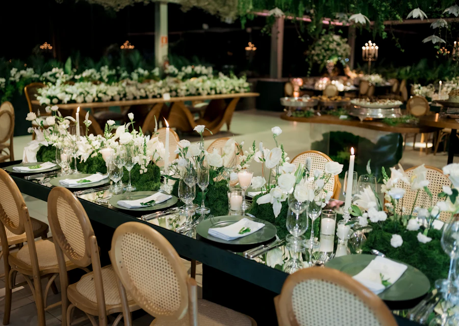 A candlelit reception table with white flowers