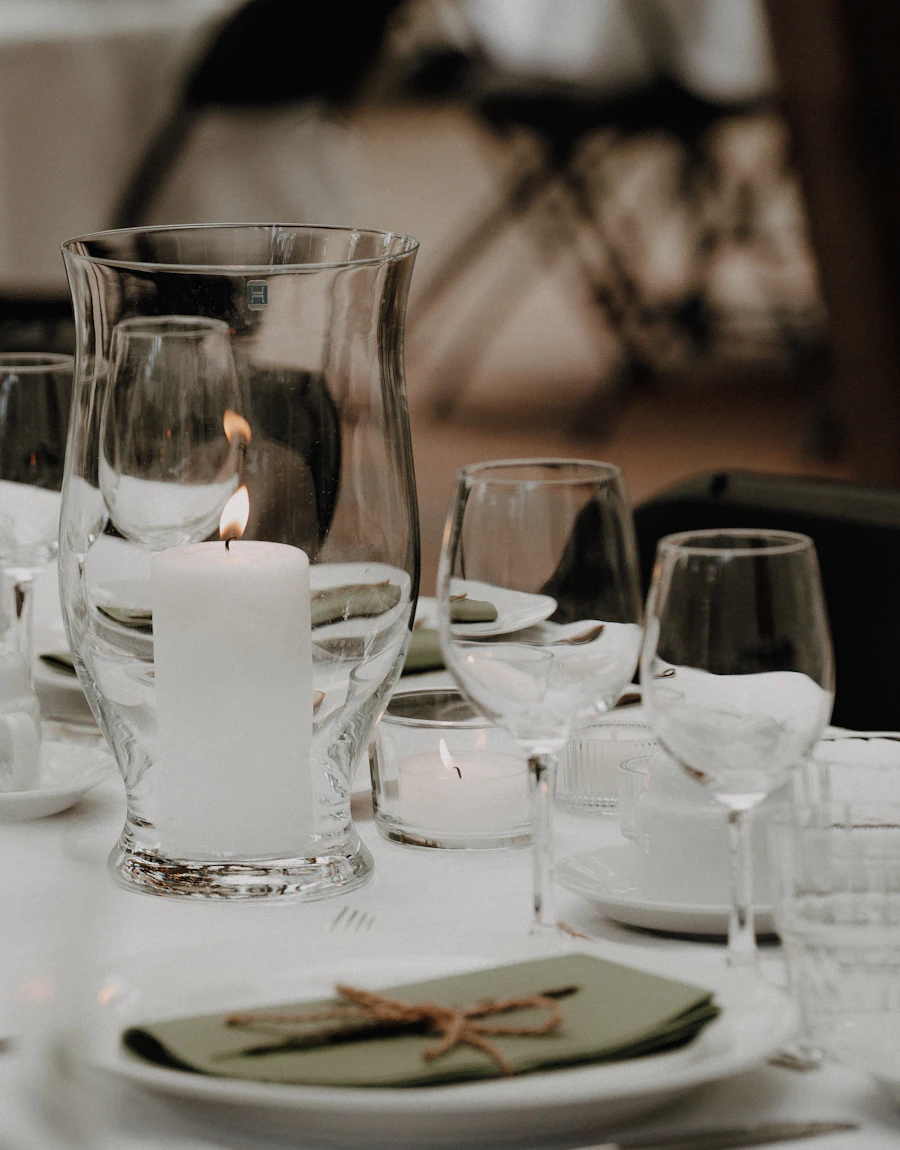 A table setting with a candle and flowers